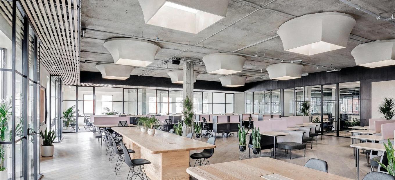 A big modern office with pink decor and plants